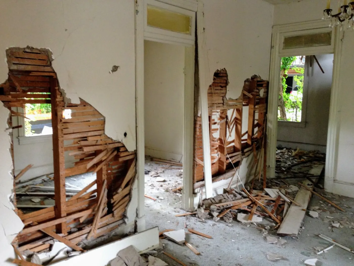 The inside of a house with holes broken through the walls during training