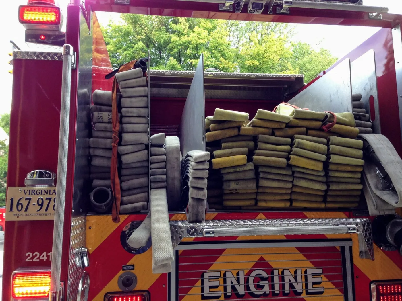 The back of a fire engine with hose packed in its beds