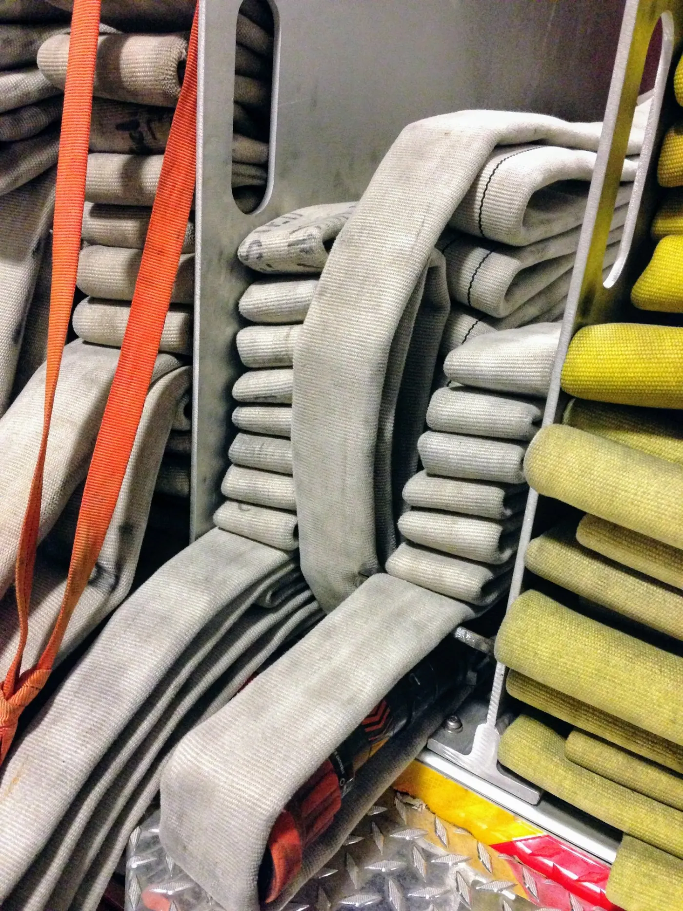 A close look at fire hose folded and packed in the engine