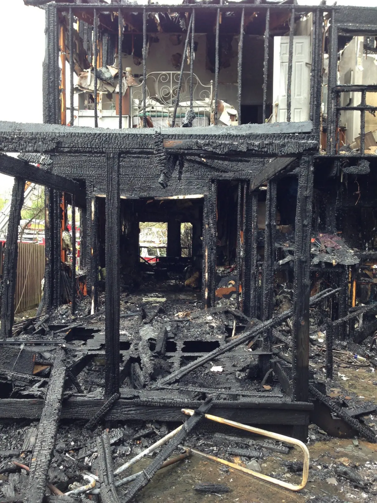 The burned frame of a house after a fire