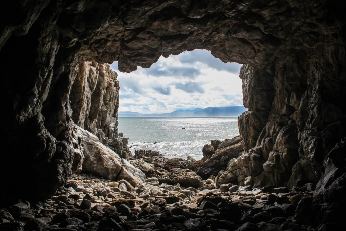 The sea seen through the mouth of a dark cave